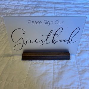 “PLEASE SIGN OUR GUESTBOOK” sign